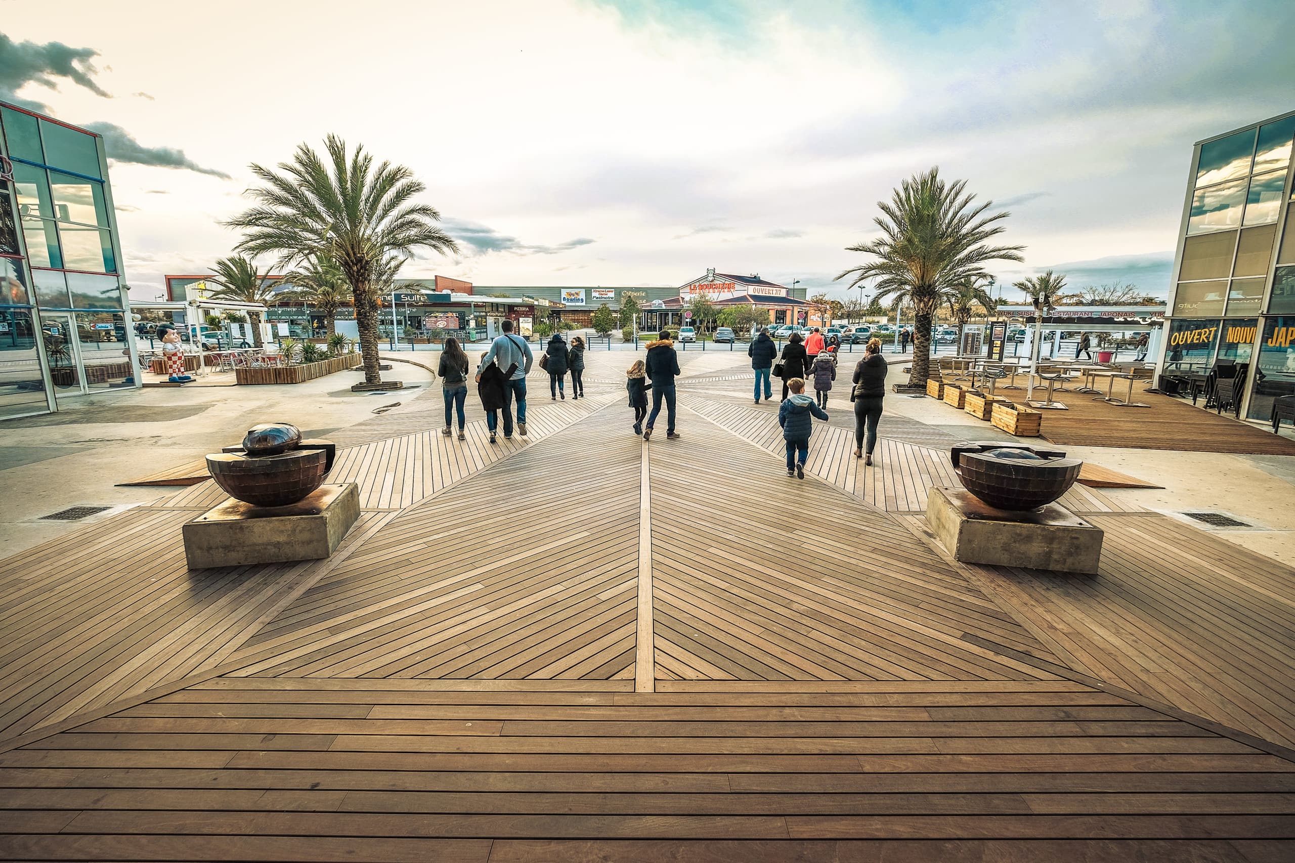 Beautiful large wooden ipe decking terrace on an esplanade in the south of France next to a cinema by Côté Jardin