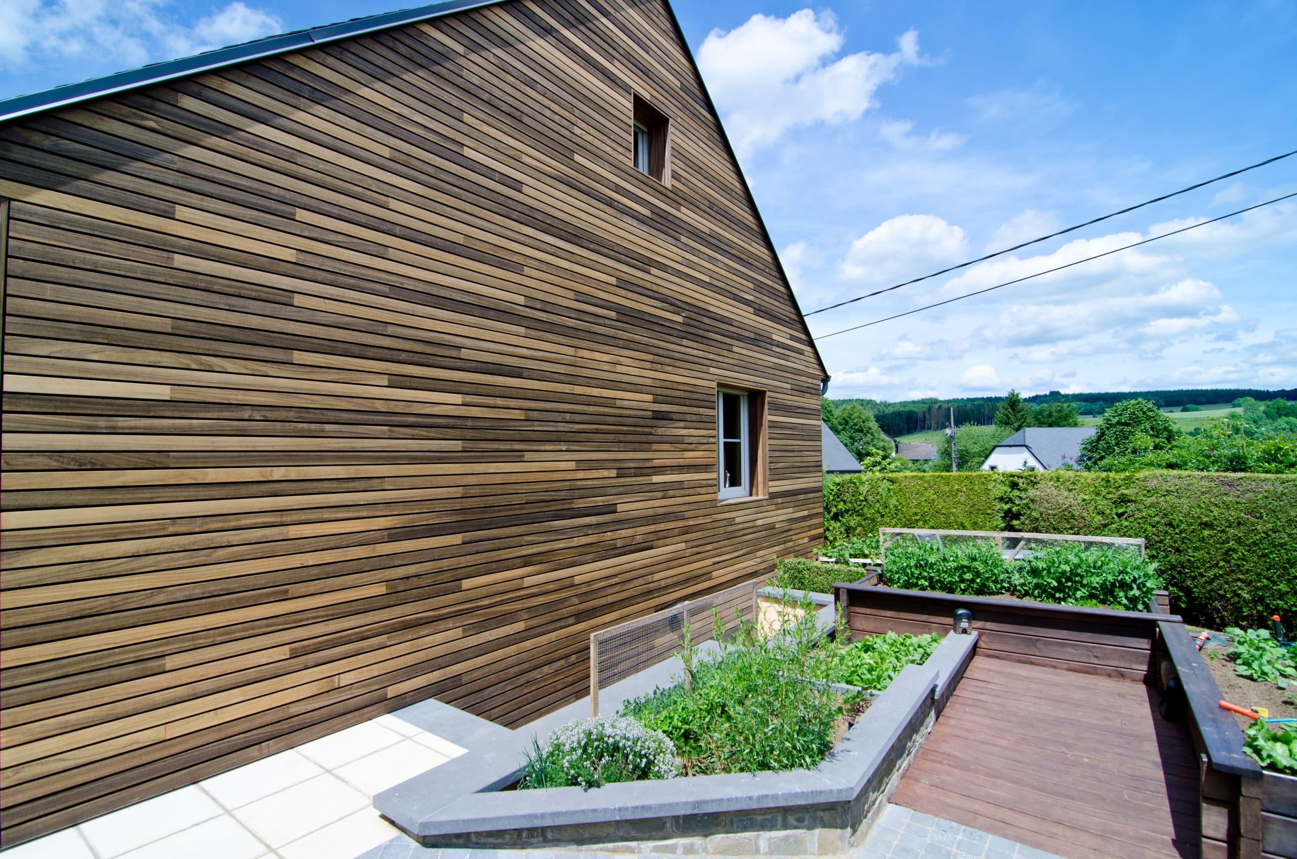 Wood cladding on a house in Belgium full of wood padauk exotic window cladding without visible fixations