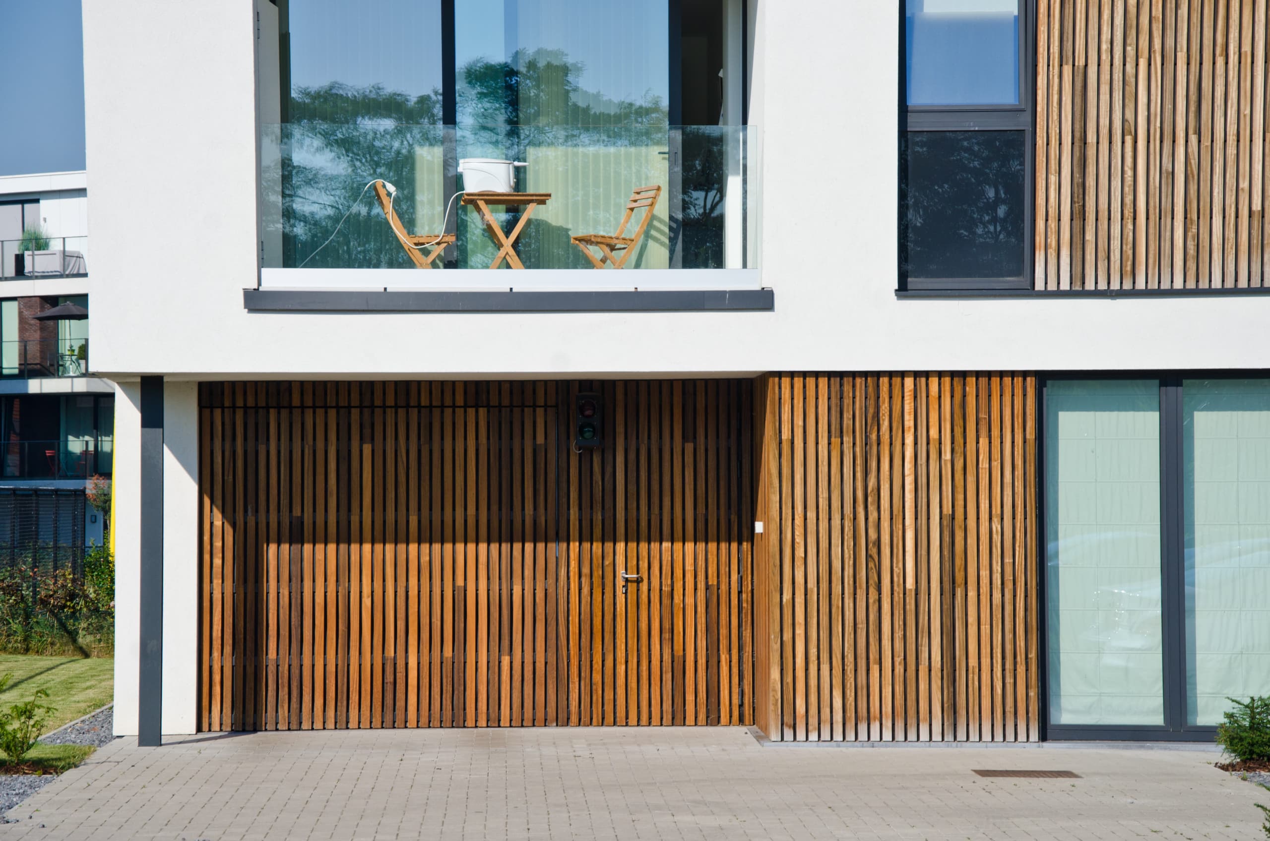 Incredible wood cladding with padauk on building in belgium with a garage door in wood cladding without visible fixations vetedy techniclic